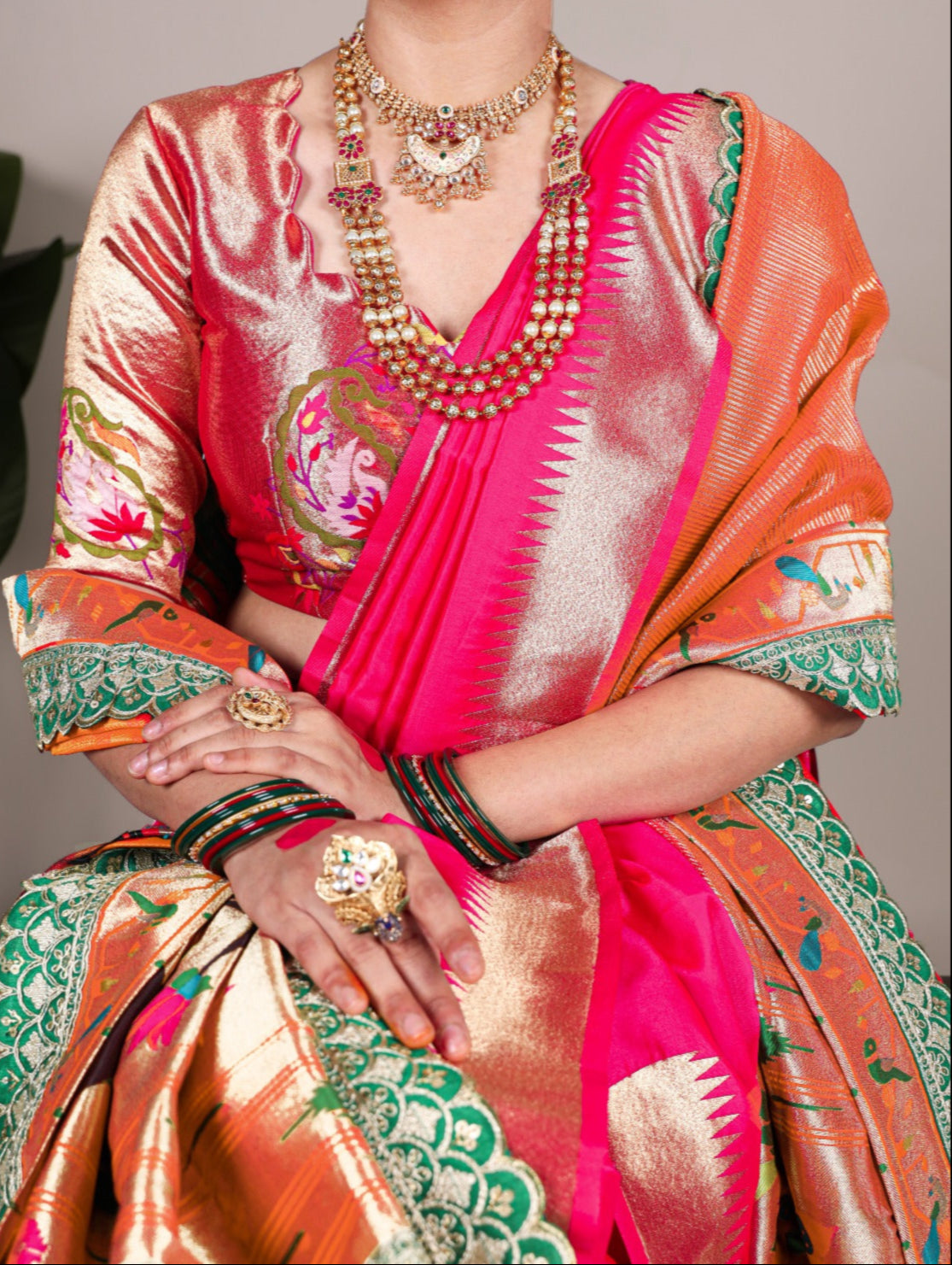 Women wearing paithani designer sarees with intricate jewelry designs 