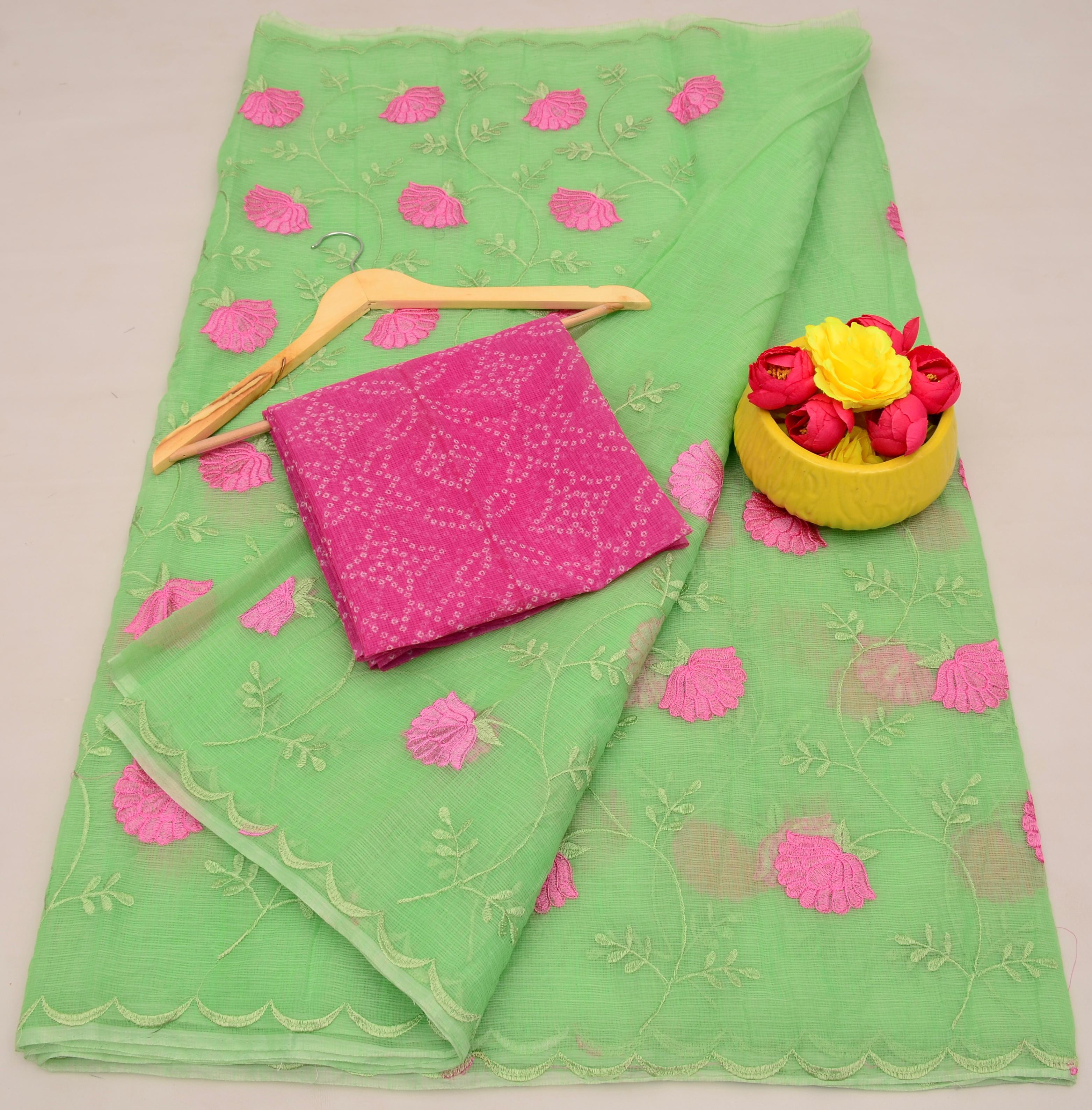 Light Green fabric with pink floral patterns, a pink folded fabric, and a yellow container with flowers on a light gray background.