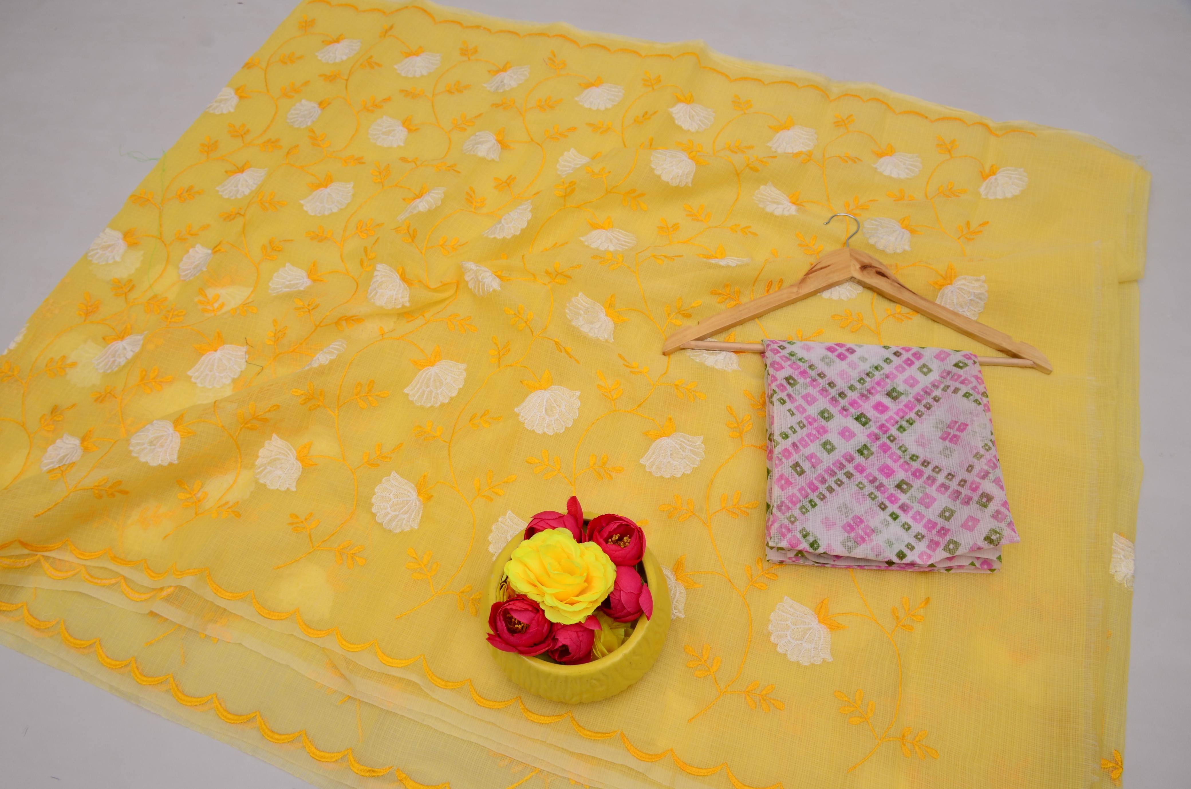 Yellow fabric with floral patterns, a pink patterned fabric, and flowers on a white background