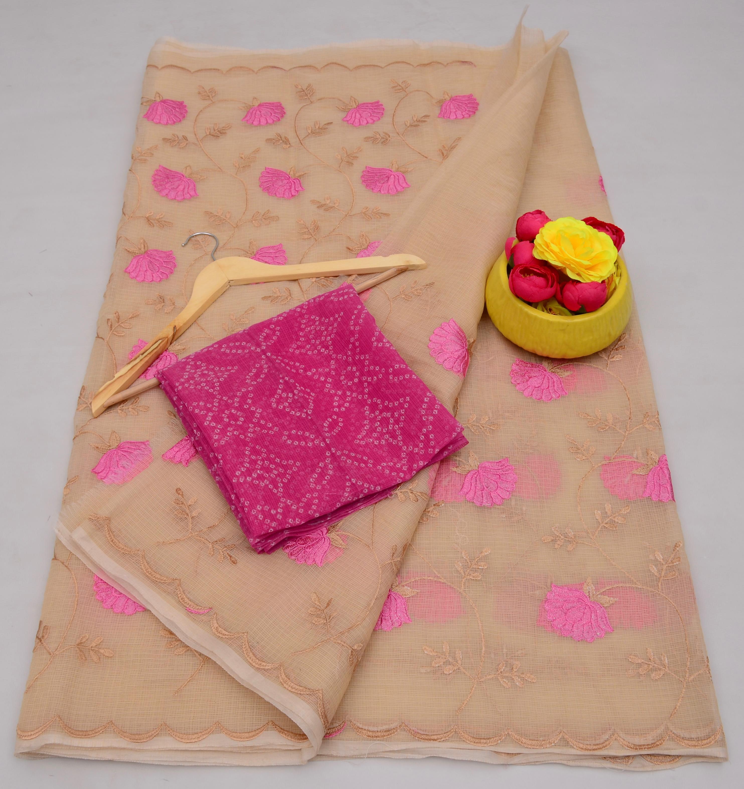 Beige fabric with pink floral patterns, pink fabric folded on top, yellow container with flowers on a light gray background