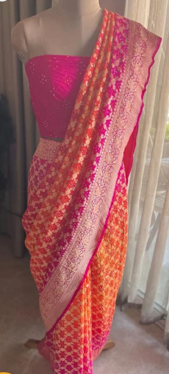 Saree with pink and orange gradient on a mannequin against a neutral background