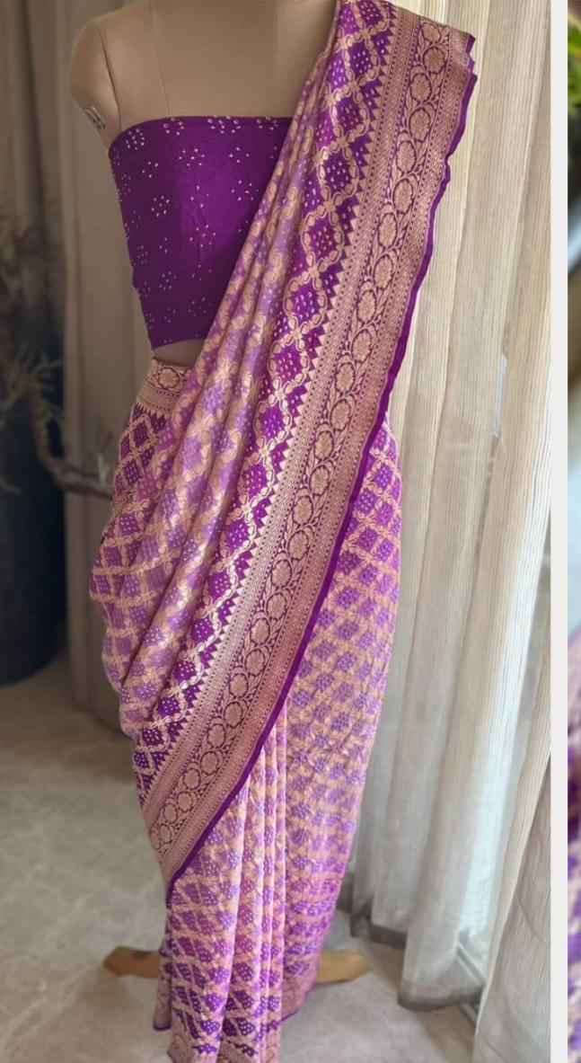Purple saree with intricate patterns on a mannequin against a neutral background