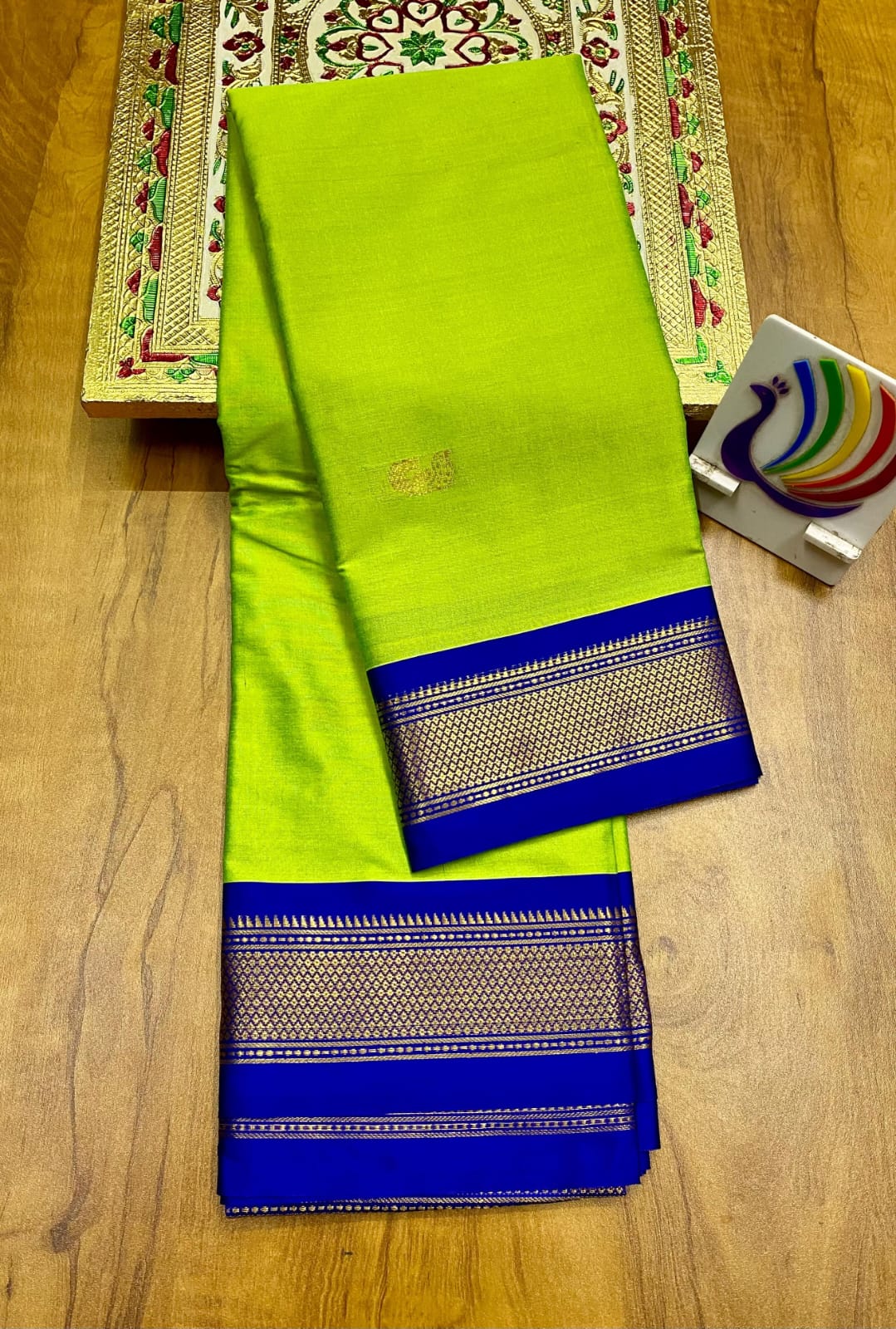 Lime Green and blue saree with a pattern on a wooden surface