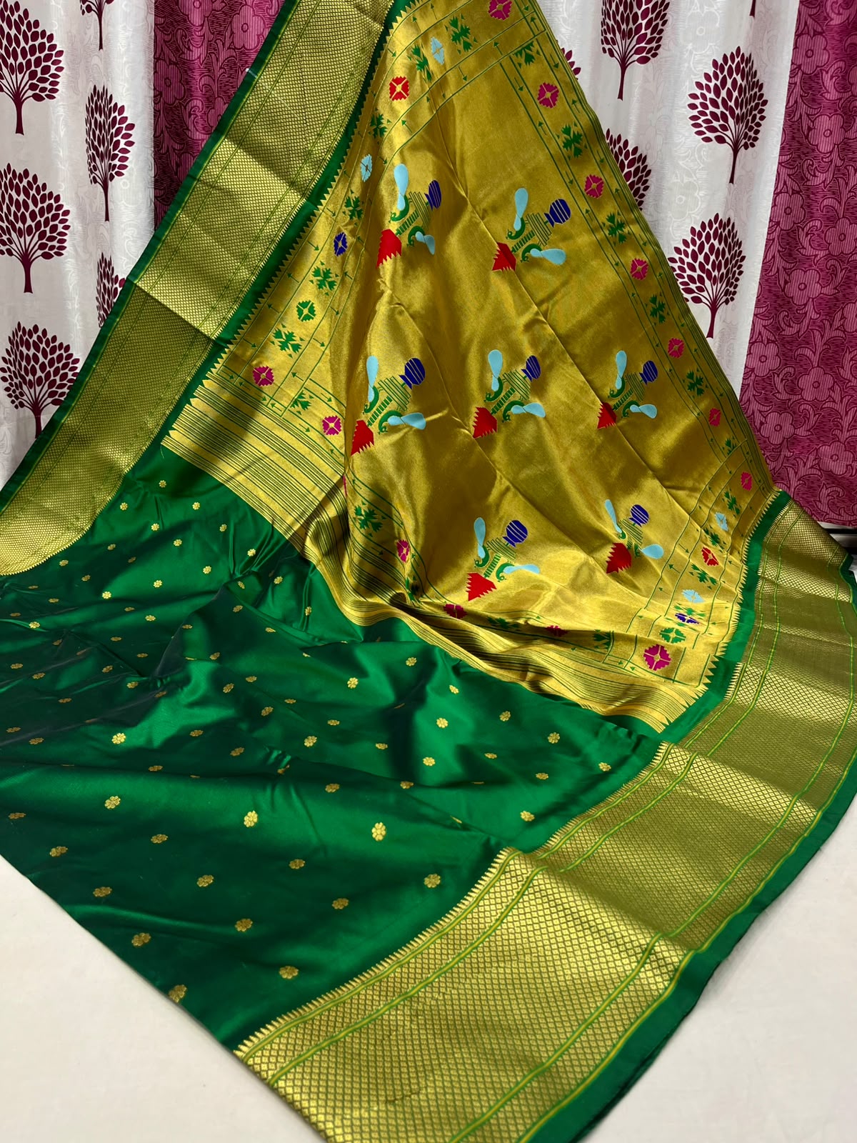 Green and golden yellow saree with floral patterns on a white background