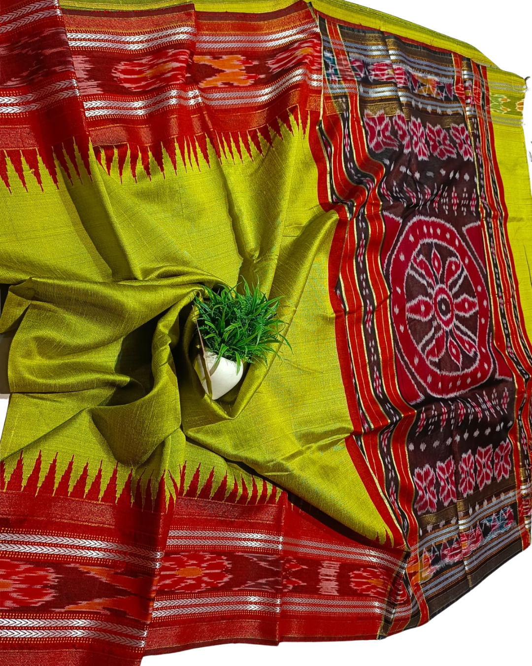 Traditional saree with red and green patterns on a white background