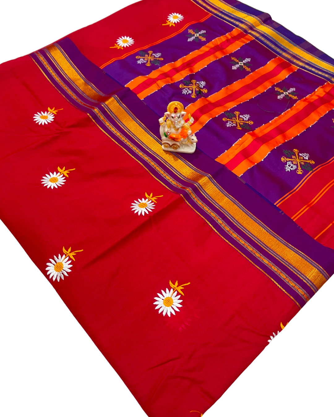 Red and purple saree with floral and cross patterns on a white background