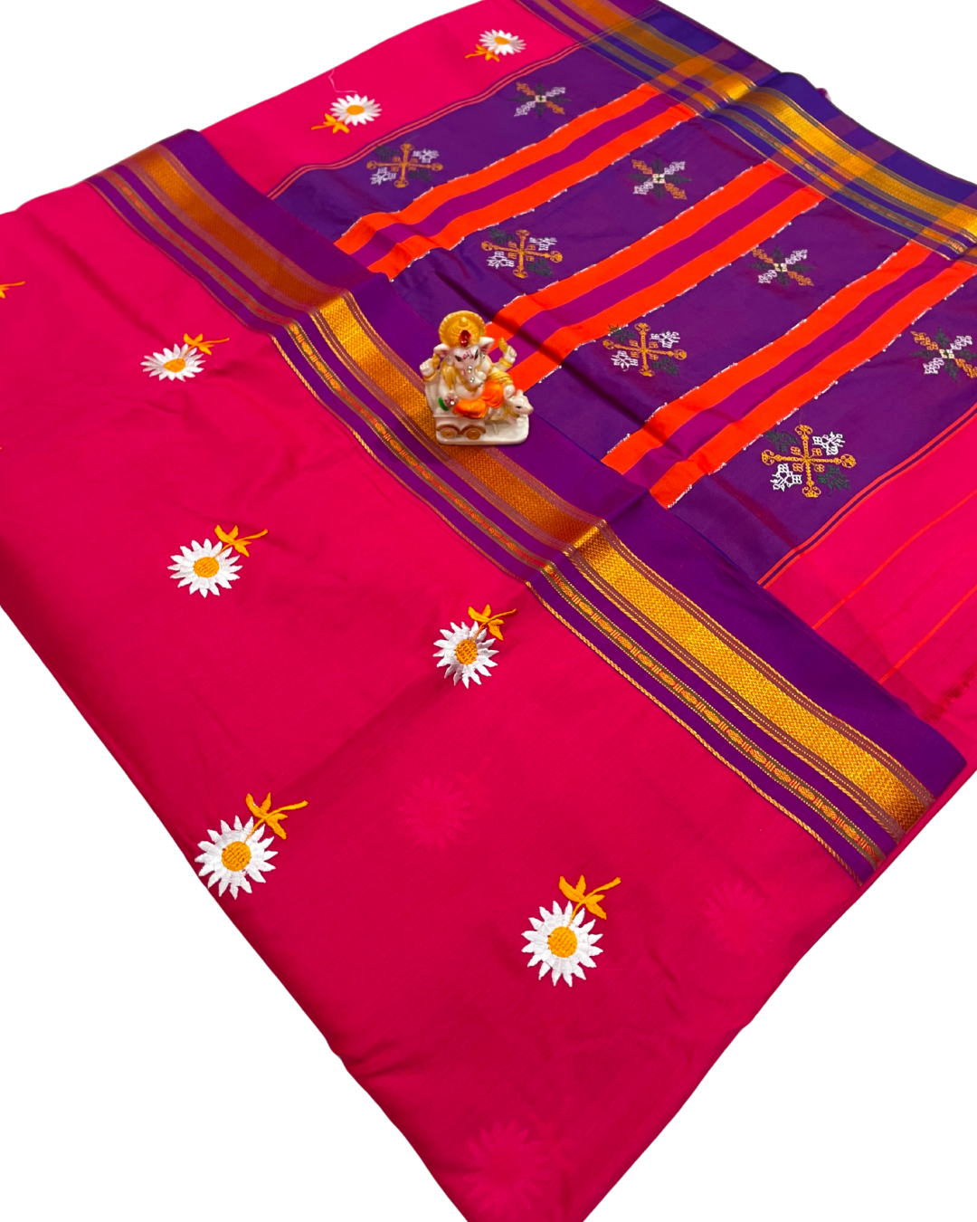 Pink and purple saree with floral patterns and a deity figure on a white background