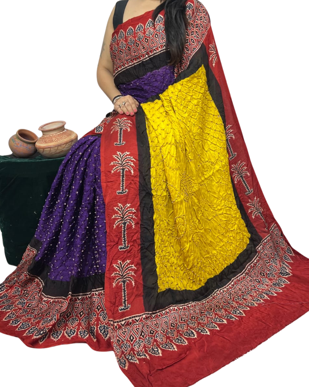 Colorful saree with a red border and yellow center on a white background