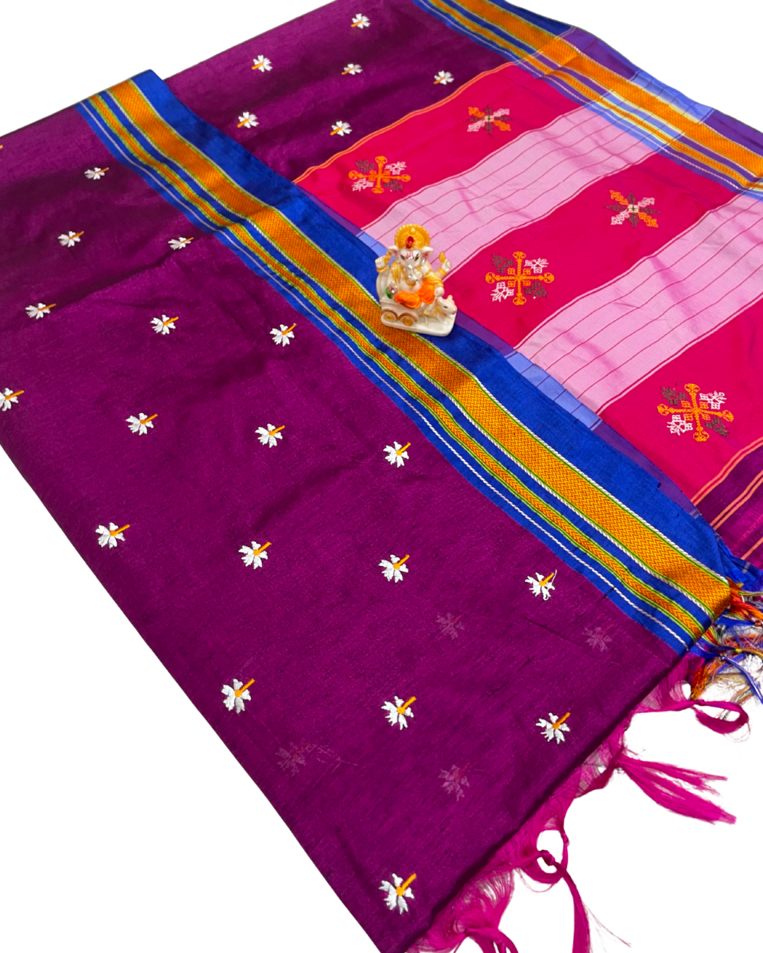 Purple saree with floral patterns and a pink border featuring religious symbols on a white background