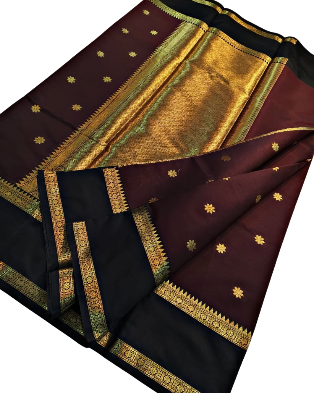A dark maroon and black silk saree with intricate gold zari borders and small gold floral motifs, displayed on a clean white background.